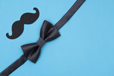 Fathers day card background on blue background. Composition of a tie, bow tie, mustache. Fathers day...