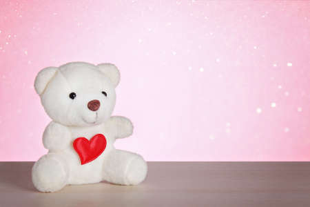 Teddy bear with heart on a pink background. Happy Valentines Day, February 14th. Valentines Day card. March 8, international womens day, mothers day.の写真素材