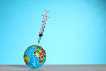 Vaccination of the world against virus. Syringe with vaccine.の写真素材