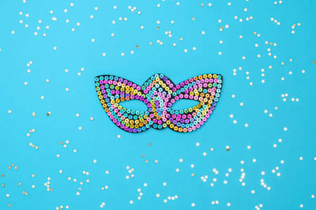 Multicolored theatrical mask on a blue background.