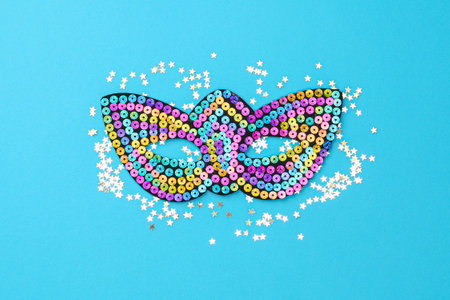 Multicolored theatrical mask on blue