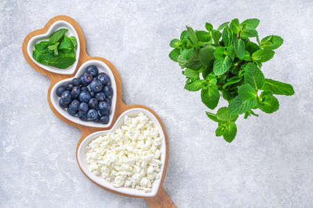 Cottage cheese with berries and mint. Cottage cheese in a bowl. Top view. Dairy products.の写真素材