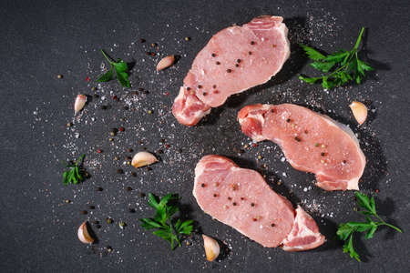 Raw pork loin. Pork meat on a gray background. Top view.