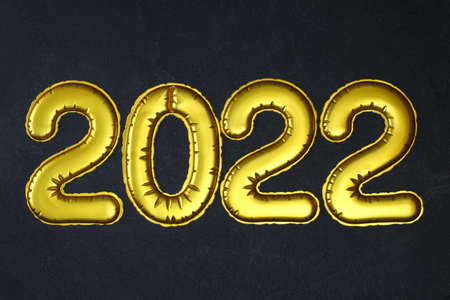 New Year 2022. Foil balloons numbers 2022 on black background. New Year Christmas.の写真素材