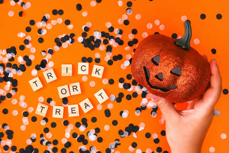 Halloween decorations on orange background. Halloween concept. Flat lay, top view. Trick or treat.の写真素材