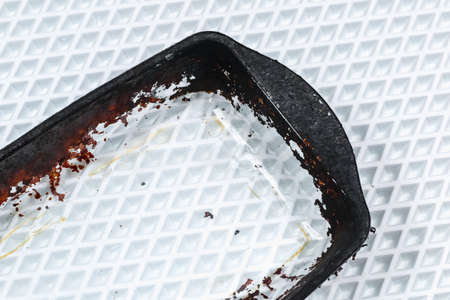 Dirty baking dish with a thick layer of carbon. Glassware for baking with soot, carbon deposits, old dried fat.の写真素材
