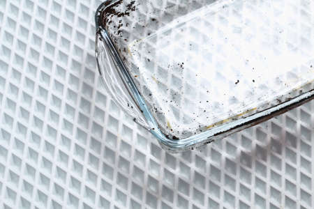 Dirty baking dish with a thick layer of carbon. Glassware for baking with soot, carbon deposits, old dried fat.の写真素材