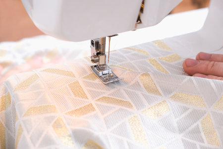 A man sews clothes on a sewing machine. Hobbies, needlework, creativity.