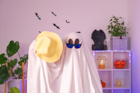 The ghost is getting ready for vacation. The ghost goes on a trip, travel, trip. Halloween concept. Neon light.の写真素材