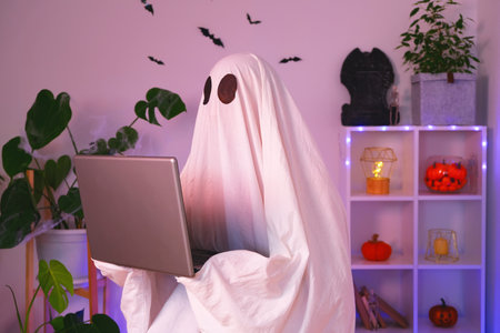 The ghost of Halloween uses a laptop to surf the Internet, to browse online stores, markets. A ghost...