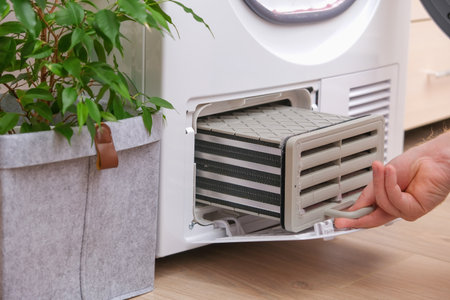 Drying machine with a full filter of lint, hair, dust, wool after the drying cycle of towels, bed...