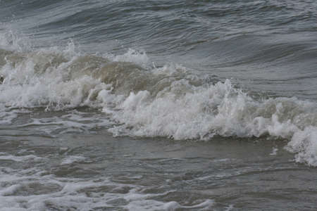 Ocean waves crashing to shore along coastline