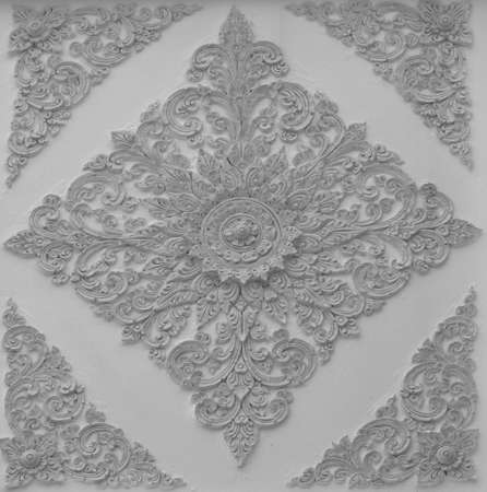 The gold stucco design of native thai style on the Wallの写真素材