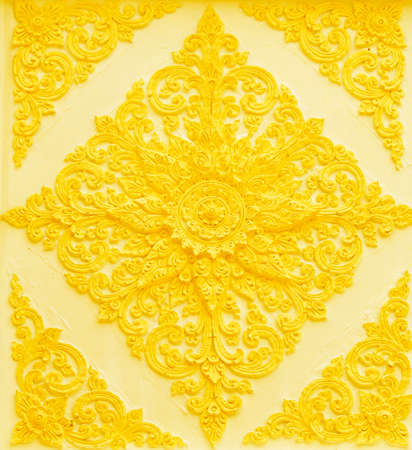 The gold stucco design of native thai style on the Wallの写真素材