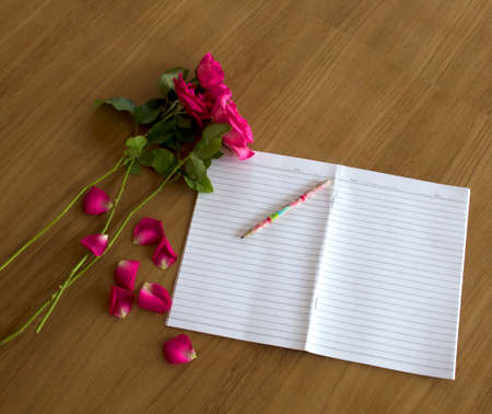 Roses on a wooden floor, Book, Pencilの写真素材