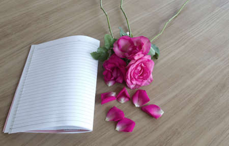 Roses on a wooden floor, Book, Pencilの写真素材