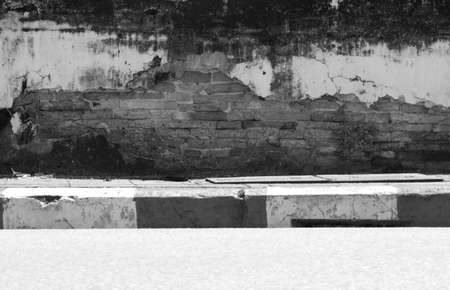 Old wall on the sidewalkの写真素材