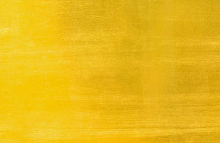 Shiny yellow leaf gold foil texture backgroundの写真素材