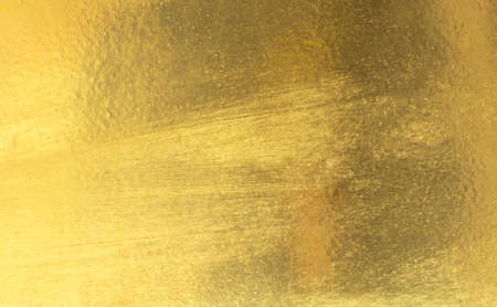 Shiny yellow leaf gold foil texture backgroundの写真素材