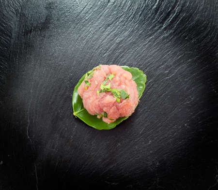 Red meat on a black stone boardの写真素材