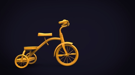 Vintage yellow toy tricycle on black backgroundの写真素材