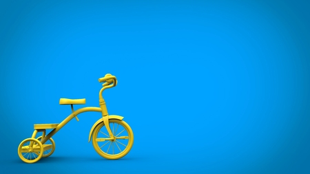 Beautiful bright yellow tricycle on blue backgroundの写真素材