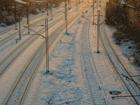 Train tracks covered in snow - evening shotの写真素材