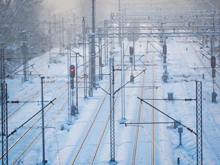 Snow covered train tracks near train stationの写真素材