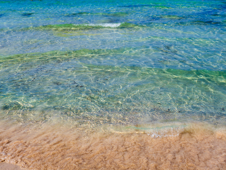 Crystal clear azure blue water and sandy beachの写真素材