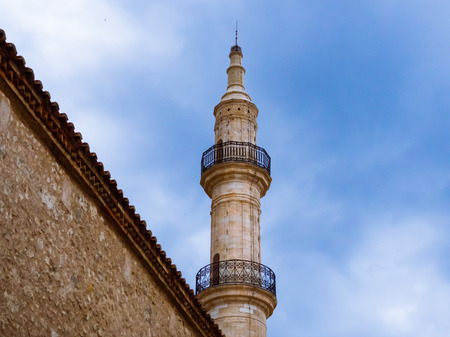 Minaret of old mosque towering over the wall in the old part of Rethymno - Crete, Greeceの写真素材