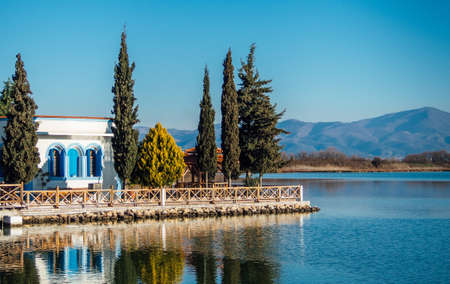 Beautiful Mediterranean style house on the lake surrounded by spruce trees