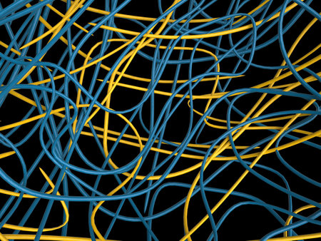 Blue and yellow wires all tangled together - isolated on black backgroundの写真素材