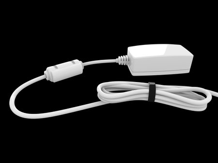 Device with white cable bent and coiled up and held with black rubber bandの写真素材