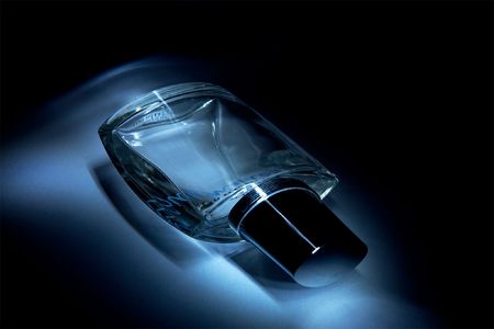 Blue perfume bottle on black backgroundの写真素材