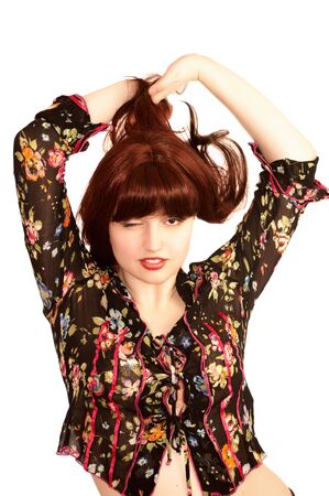 Young beautiful woman with red hair winks, isolatedの写真素材