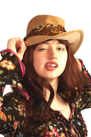 Young woman in hat winking, isolated on whiteの写真素材