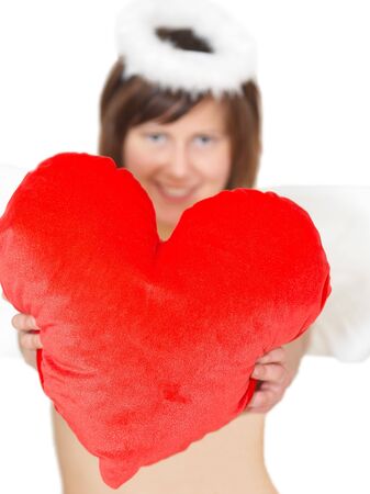 Young woman in angel's costume with red heart, isolated on whiteの写真素材