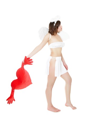 Young woman in angel's costume with red heart, isolated on whiteの写真素材