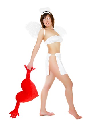 Young woman in angel's costume with red heart, isolated on whiteの写真素材