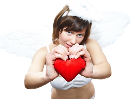 Young woman in angel's costume with red heart, isolated on whiteの写真素材