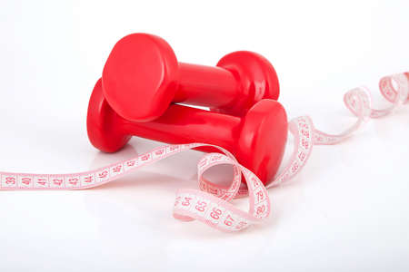 Two of dumbbells Isolated on white background wish measuring tapeの写真素材