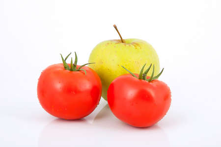 Two isolated tomato with apple on white backgroundの写真素材