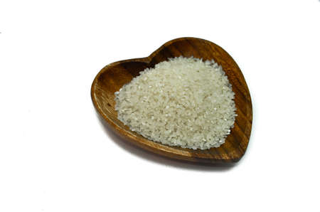 Beautiful rice grains with herbs in a wooden plate. For you.の写真素材