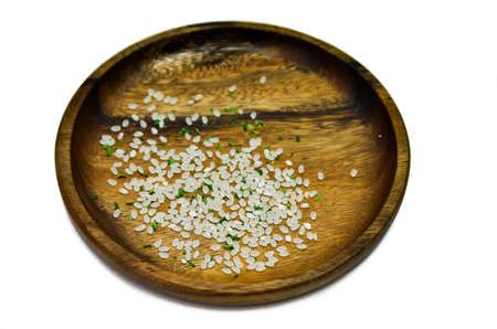 Beautiful rice grains with herbs in a wooden plate. For you.の写真素材