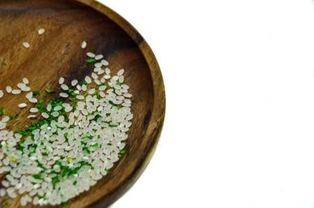Beautiful rice grains with herbs in a wooden plate. For you.の写真素材