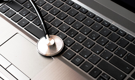 Stethoscope resting on a computer keyboard  concept for online medicine or IT supportの写真素材
