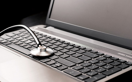 Stethoscope resting on a computer keyboard  concept for online medicine or IT supportの写真素材