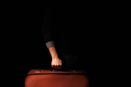 man holding a suitcase for a trip.の写真素材