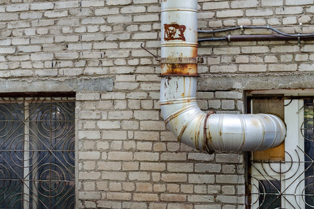 Industrial Flue Pipe Coming Out Of The Windows Along The Wall Of The Plant