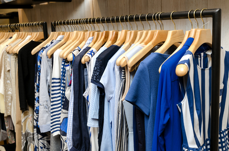 Multi-Colored Women's Clothing On Wooden Hangers. Blouses, Shirts, Trousers, Jackets.の写真素材